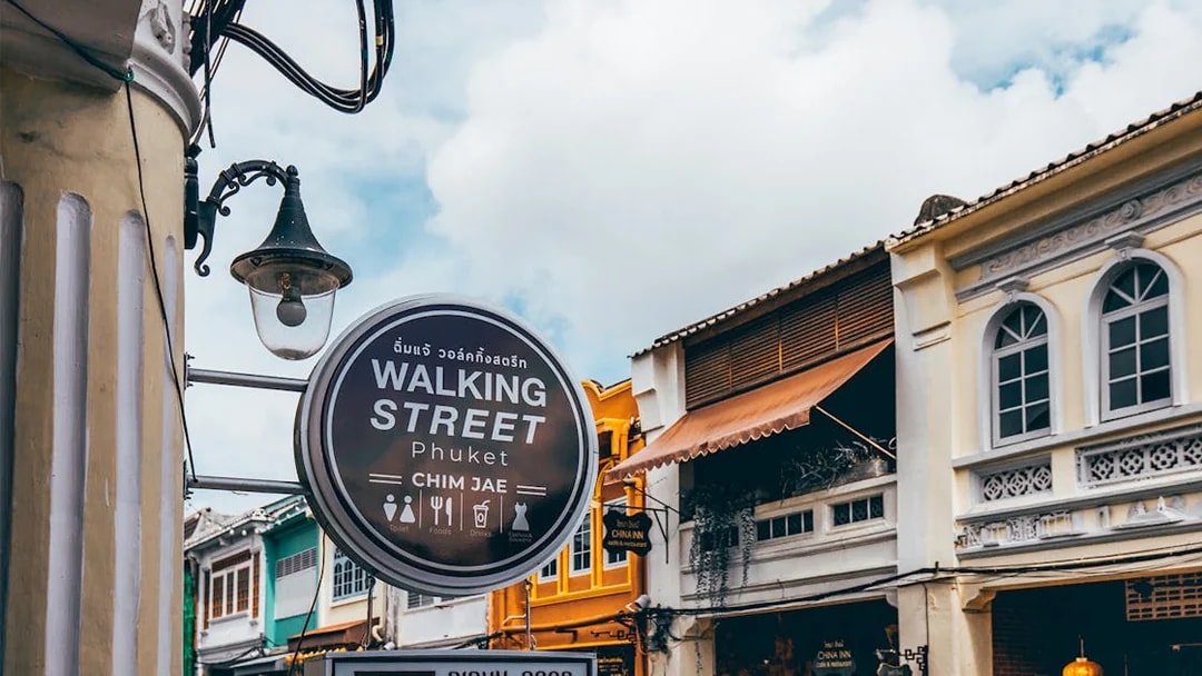Walking Street sign and colorful buildings in Phuket, Thailand.