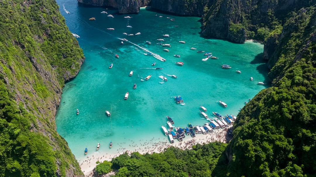 Aerial view of boats and tourists at Maya Bay, Phi Phi Island, Thailand.