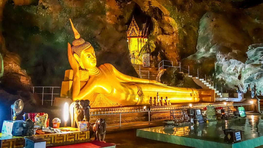 Reclining Buddha statue inside Wat Suwan Kuha temple cave, Thailand.