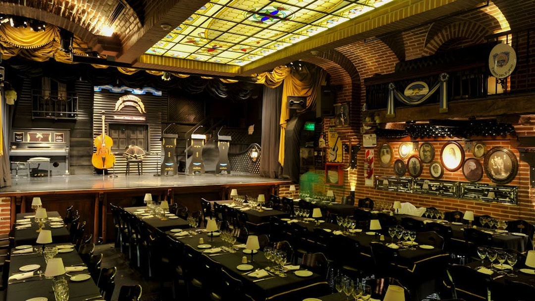Elegant theater setup for Piazzolla Tango Show in Buenos Aires, featuring stage and dining tables.
