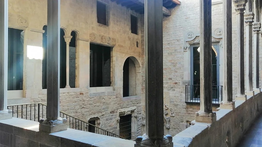 Stone courtyard with arches and columns at Picasso Museum, Barcelona.