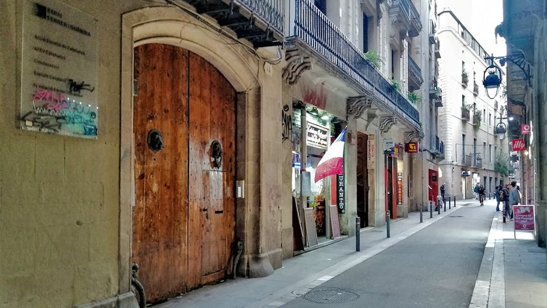 Narrow street in Barcelona with historic buildings on the Picasso Walking Tour route.