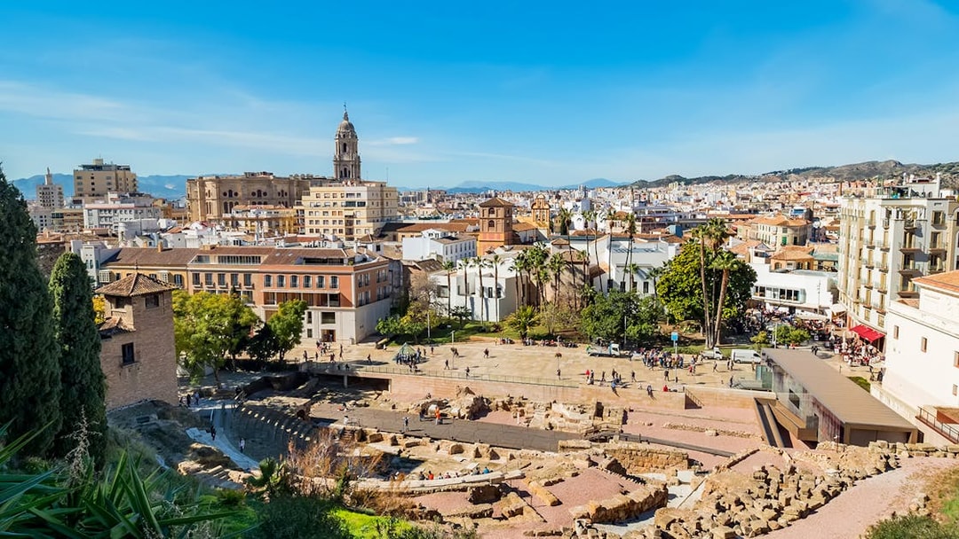 Roman Theatre ruins with Malaga cityscape near Picasso Museum.