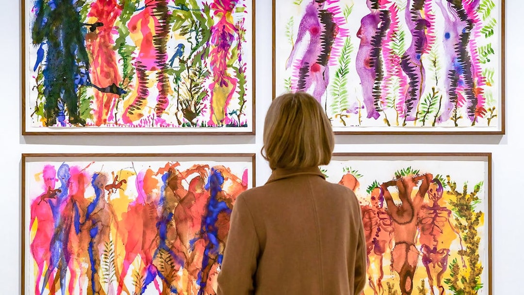 Visitor viewing colorful abstract paintings at Picasso Museum Malaga.