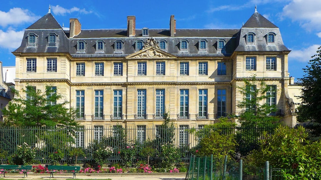 Picasso Museum exterior in Paris with garden and blue sky.