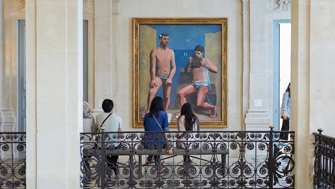Visitors viewing a large painting in a museum gallery.