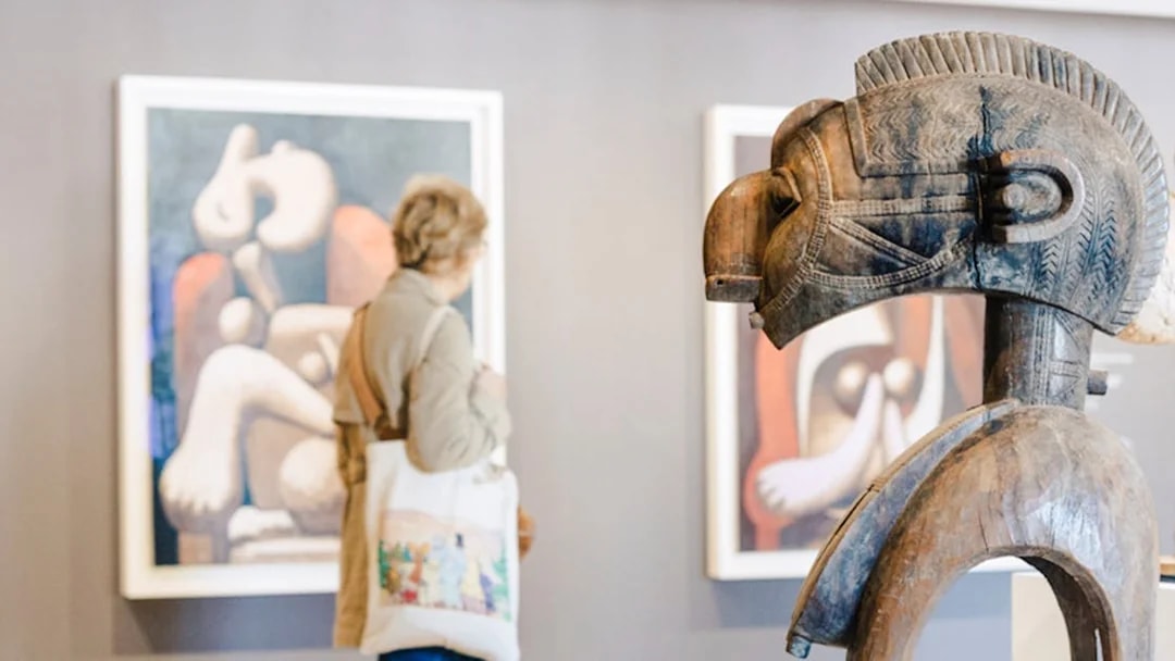 Wooden sculpture and abstract paintings in Picasso Museum, Paris, France.