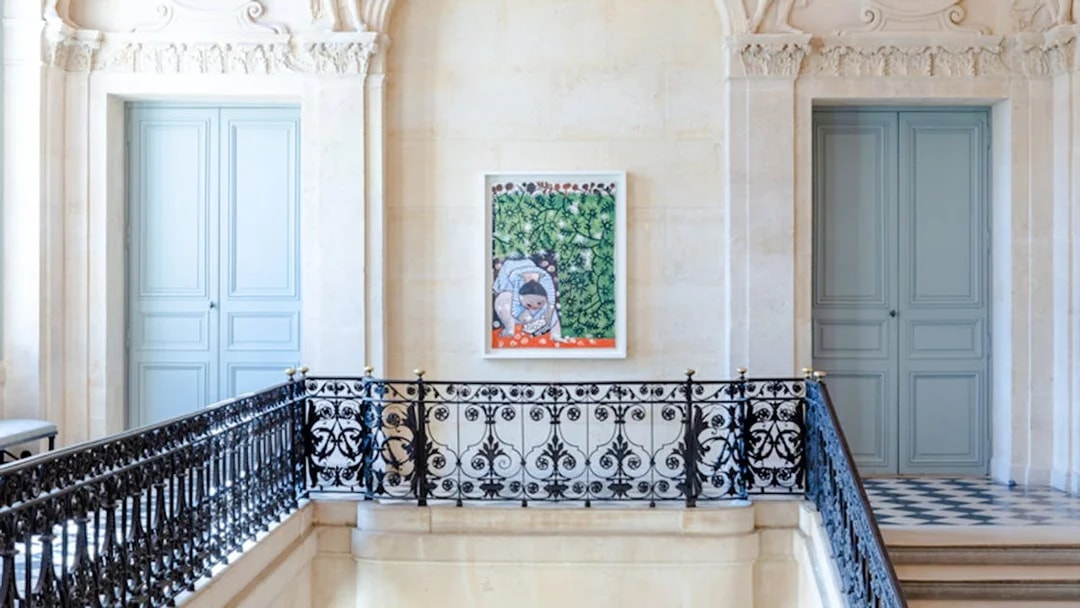 Artwork displayed in the Picasso Museum, Paris, featuring a colorful painting on a decorative wall.