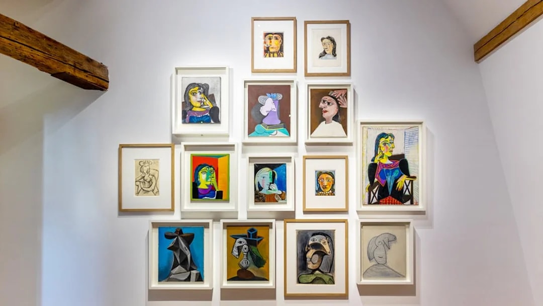 Picasso Museum art display with various framed paintings and sketches.