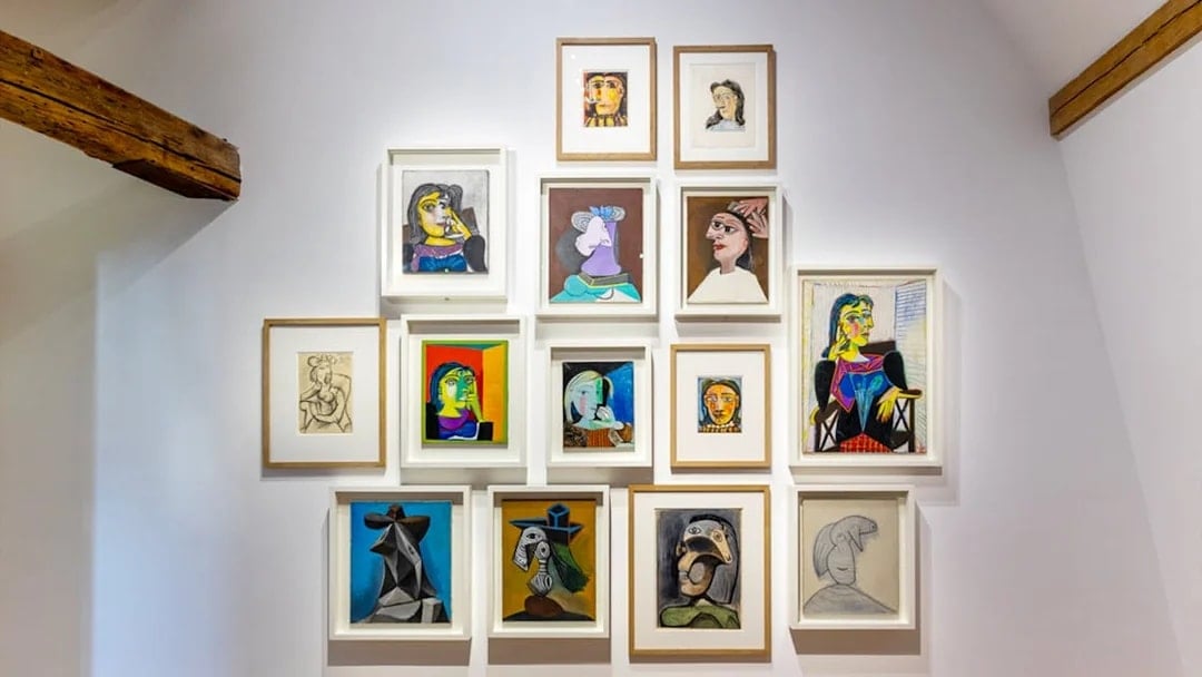Picasso Museum art display with various framed paintings and sketches.