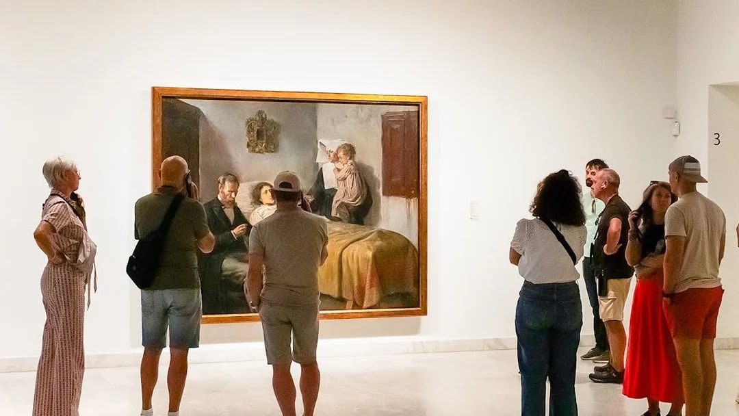 Visitors viewing a painting at the Picasso Museum during a skip-the-line guided tour.