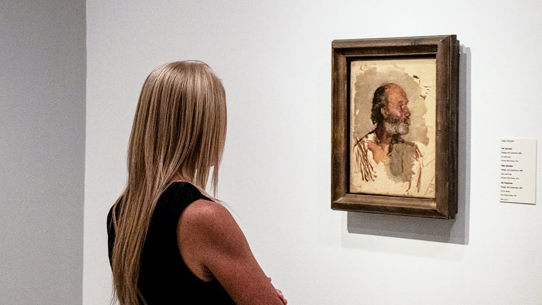 Visitor viewing a Picasso painting at the Picasso Museum during a guided tour.