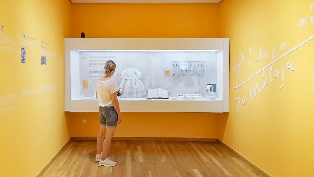 Visitor observing exhibit at Picasso's Birthplace Museum in Málaga.
