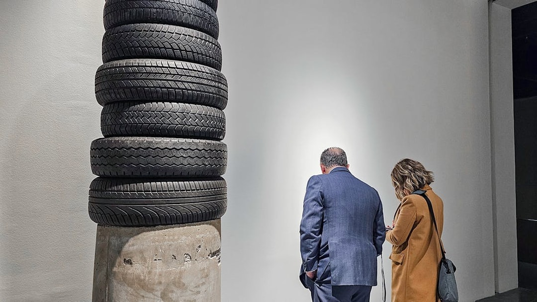 Visitors observing tire sculpture at Picasso's Birthplace Museum.