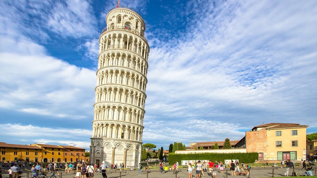 Leaning Tower of Pisa with tourists in Piazza dei Miracoli, Italy.