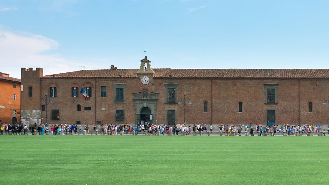 Sinopie Museum Pisa exterior with visitors and historical fresco sketches on facade.