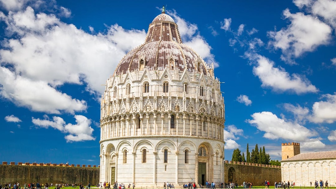 Baptistery in Pisa with tourists on a guided tour.