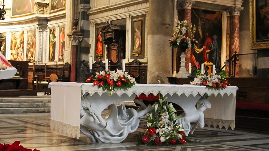Altar inside Pisa Cathedral with ornate decorations and religious artwork.