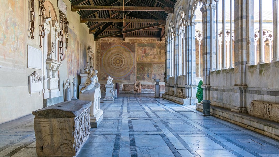 Pisa Camposanto interior with sculptures and frescoes, located in Pisa Cathedral Square.