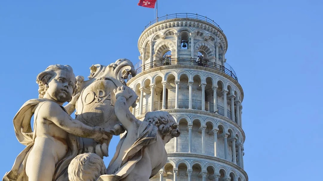 Fountain of the Putti with Leaning Tower of Pisa in background, Pisa, Italy.