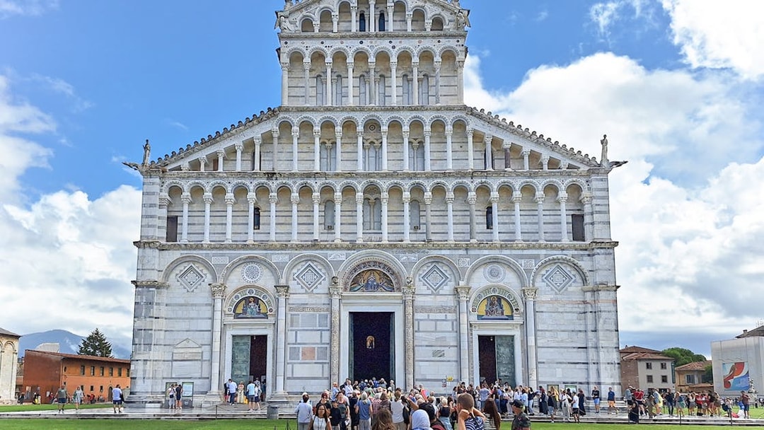 Visitors entering Pisa Cathedral in Italy.