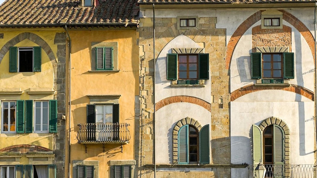 Colorful historic buildings in Pisa, Italy, seen on a guided walking tour.