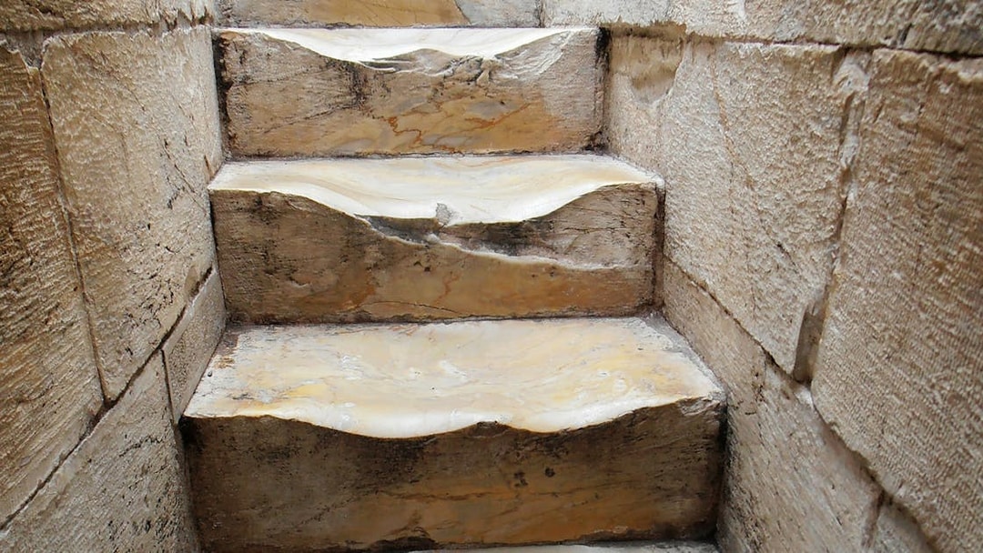 Worn stone steps inside the Leaning Tower of Pisa, Italy.