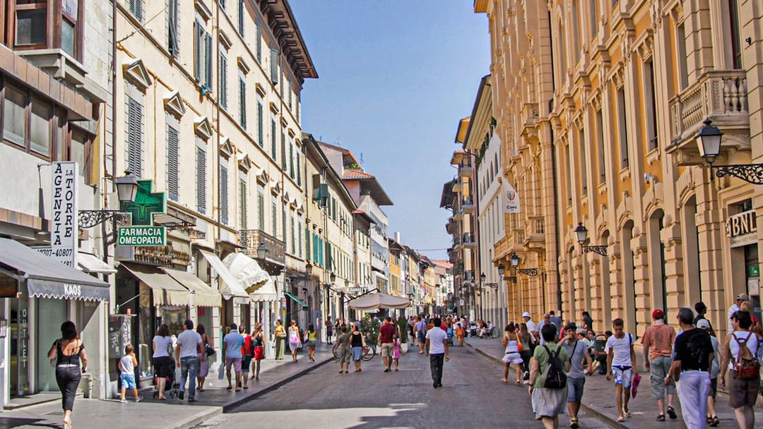 Pisa street scene with tourists walking, part of a 3-hour guided tour.