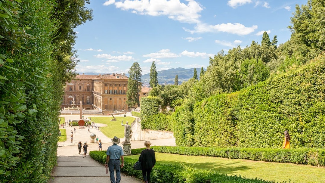 Visitors walking towards Pitti Palace through Boboli Garden in Florence, Italy.