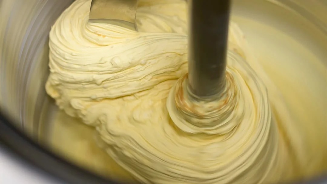 Fresh gelato being churned in an ice cream maker.