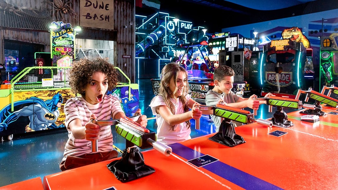 Children playing arcade games at Play DXB indoor amusement park.