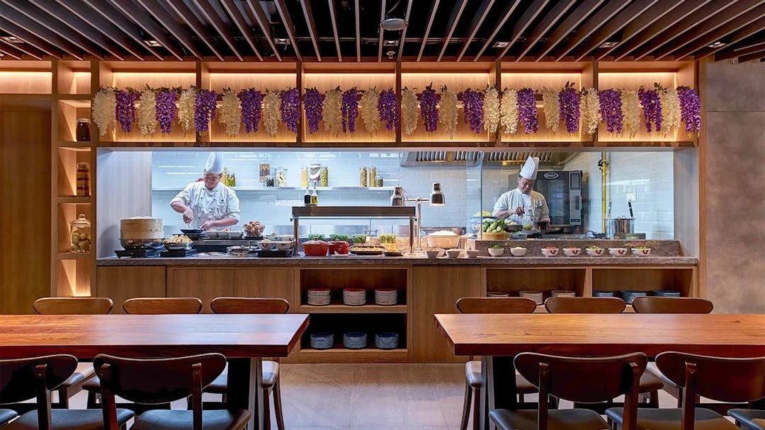 Chefs preparing dishes at Plaza Premium First lounge, Satellite Terminal.