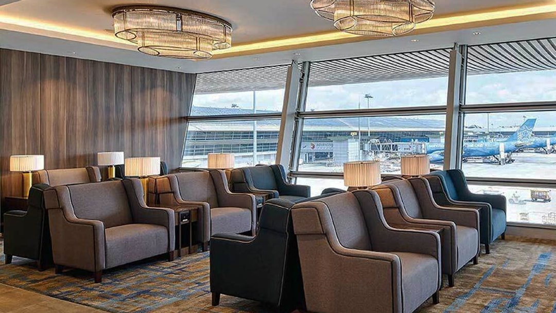 Plaza Premium First lounge seating area with airport view, Satellite Terminal.