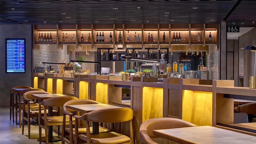 Plaza Premium Lounge seating and bar area at Kuala Lumpur International Airport.