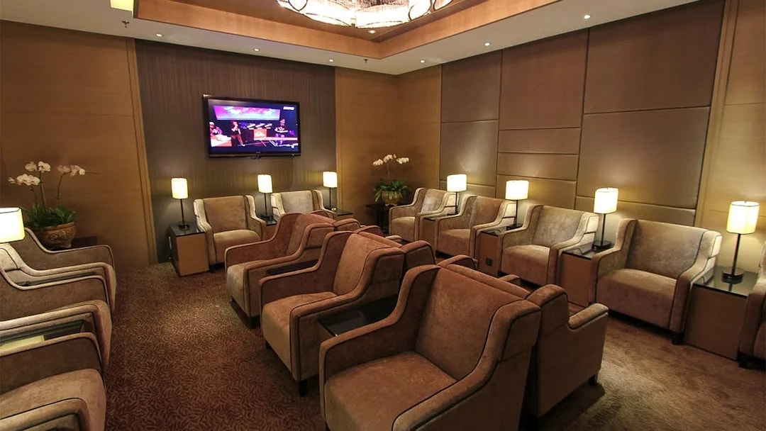 Plaza Premium Lounge seating area with armchairs and lamps, Kuala Lumpur airport.