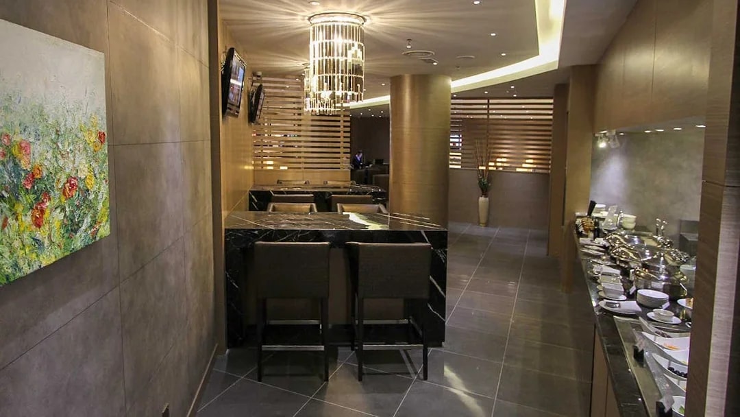Plaza Premium Lounge interior with seating and buffet area.