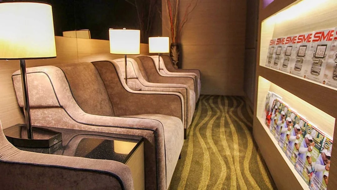 Plaza Premium Lounge seating area with armchairs and reading materials.