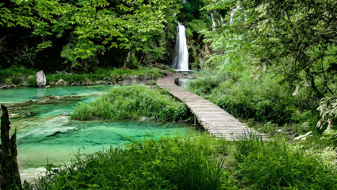 Wooden path leading to a waterfall at Plitvice Lakes National Park, Croatia.