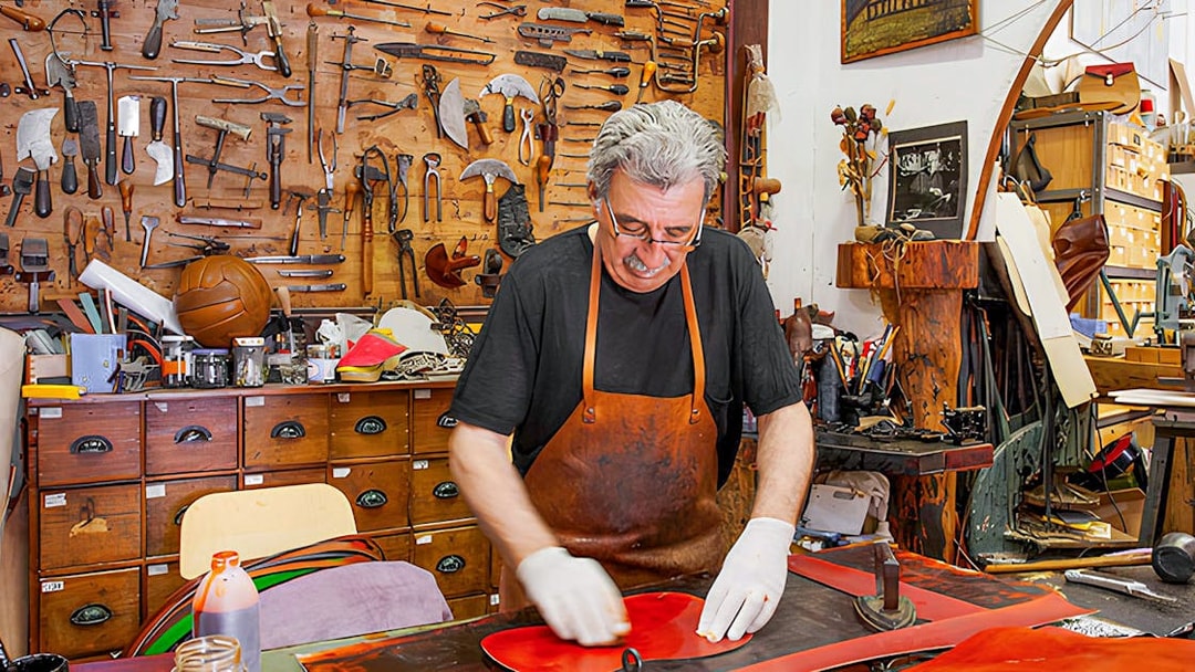 Craftsman working in a leather workshop at Poble Espanyol, Barcelona.