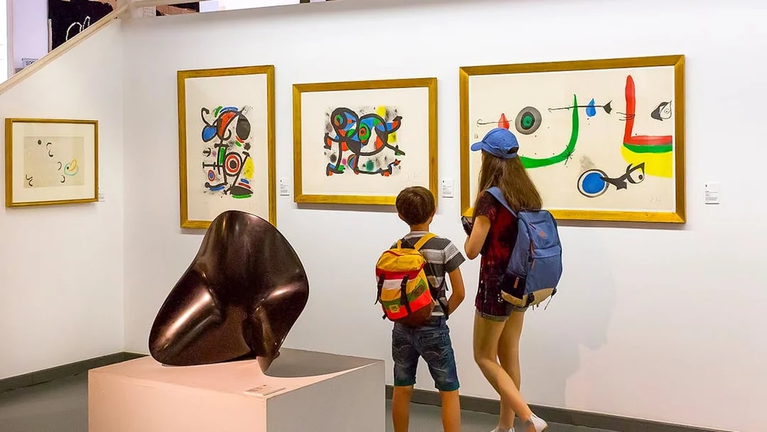 Visitors viewing modern art at Poble Espanyol, Barcelona.