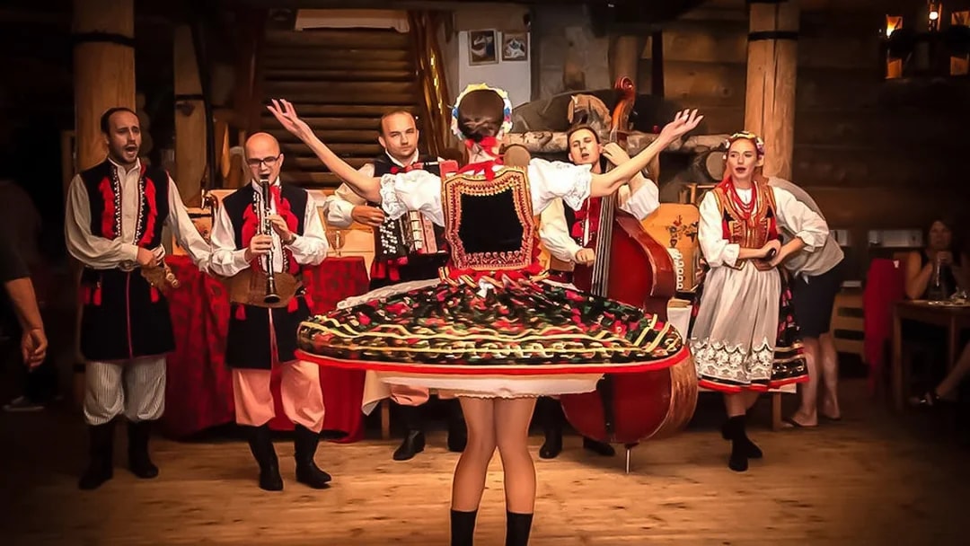 Polish folk dancers and musicians performing at a traditional dinner event.