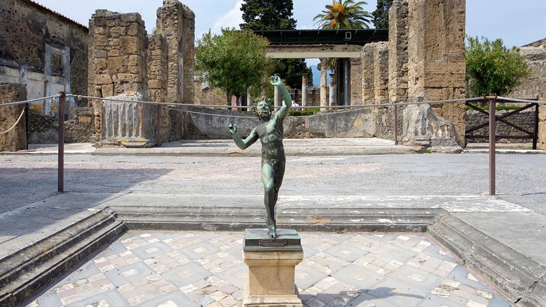 Bronze statue in the atrium of the House of the Faun, Pompeii Ruins.