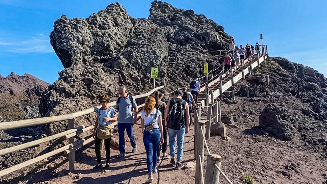 Tourists hiking on a trail at Mount Vesuvius, Italy.
