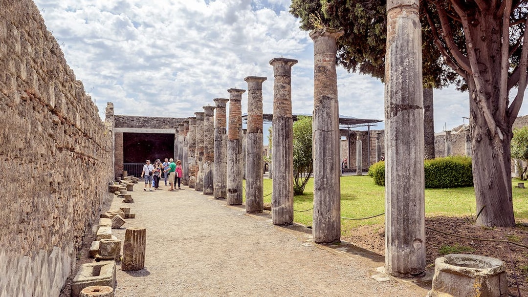 Group exploring ancient columns on a 2-hour private guided tour of Pompeii.
