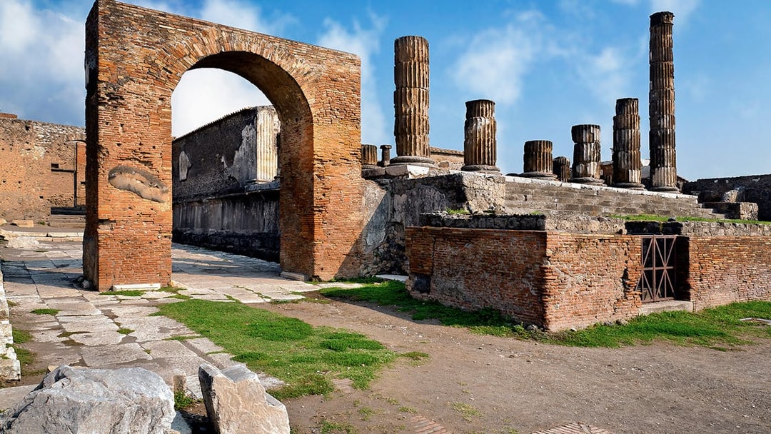 Ancient ruins and columns in Pompeii, Italy, part of a skip-the-line guided tour.
