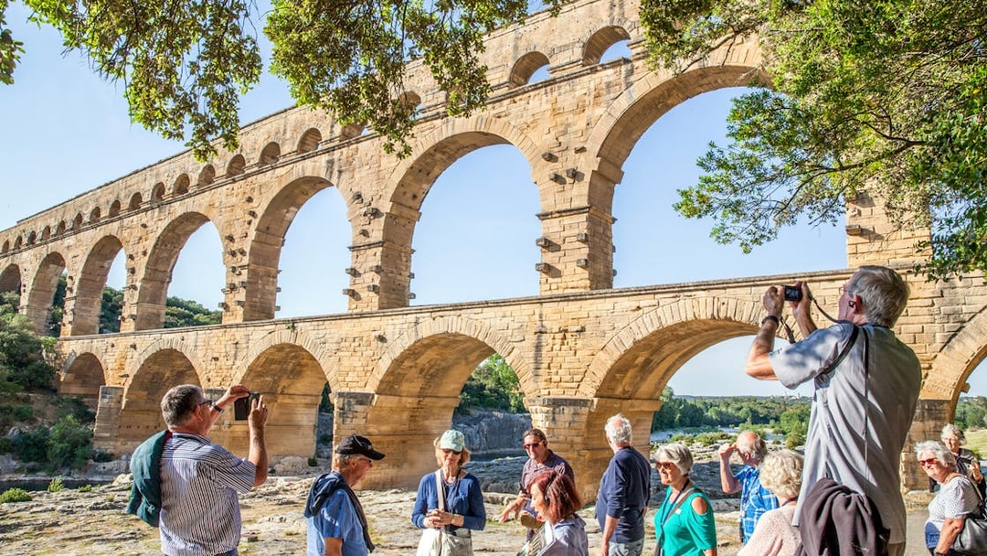 Visitors exploring Pont du Gard aqueduct in France with skip-the-line tickets.