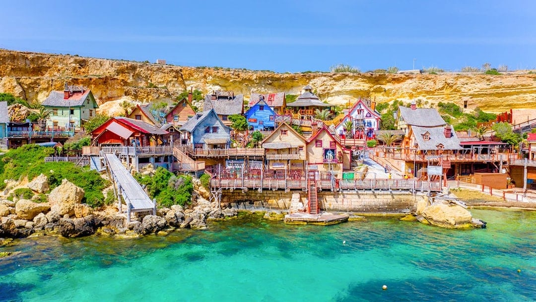 Aerial view of colorful wooden buildings at Popeye Village, Malta.