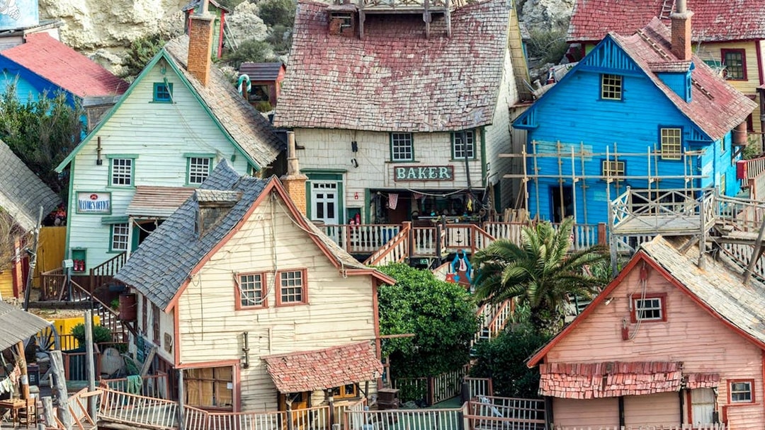 Colorful wooden buildings at Popeye Village, Malta, showcasing the unique architecture of the film set.