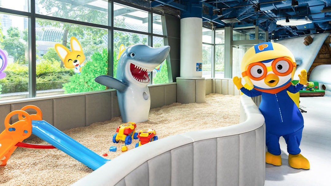 Pororo character and shark statue in play area at Pororo Park Singapore.