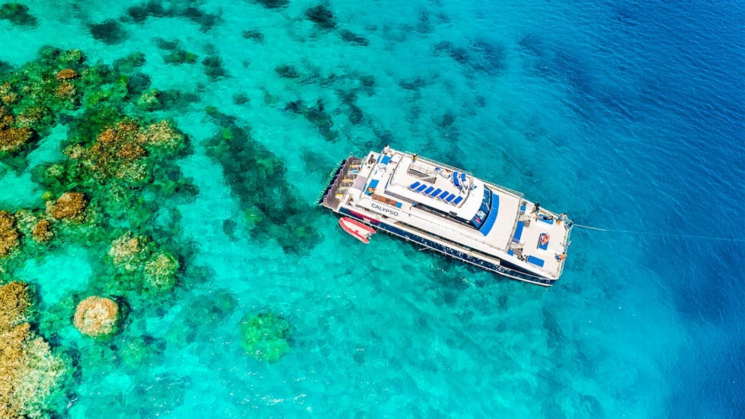 Cruise ship near coral reefs on Port Douglas to Low Isles Island route.
